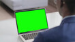 © stockbakers - Young African Businessman Using Laptop with Green Screen