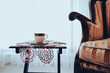turkish coffee and lace doily under coffee, vintage style armchair wooden, curtain behind them near window