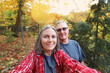 © soupstock - Middle aged senior couple walking in the autumn woods
