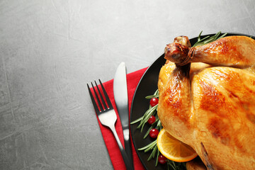 Canvas Print - Delicious cooked turkey served on grey table, flat lay with space for text. Thanksgiving Day celebration