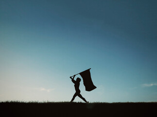 Silhouette of Woman Walking with Flag