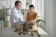 © DragonImages - Woman Bringing Dog to Veterinarian
