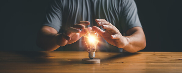Poster - businessman protect light bulb, Creative new idea. Innovation, brainstorming, inspiration and solution concepts...