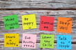 Healthy lifestyle and physical, emotional, mental social and intellectual wellbeing concept. Colorful sticky notes reminder set in wooden background with copy space.