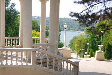 Wall Mural - Moldova. Kishinev. 08.28.2022. Arbor with white columns and a view of the lake. Park Valea Morilor.