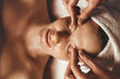 © Strelciuc - Caucasian freckled woman enjoying facial massage with closed eyes in spa salon. Beauty, spa, healthy lifestyle Facial massage at home. Massage the skin around