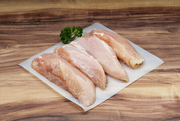 Boneless Chicken Fillet with parsley on wax paper