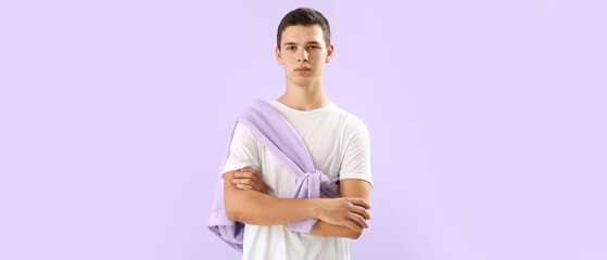 Canvas Print - Teenage boy in t-shirt on lilac background