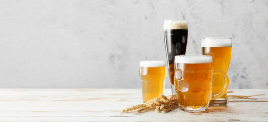 Wall Mural - Glassware with fresh beer on light background with space for text