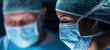 © Acronym - Diverse team of professional medical surgeons perform surgery in the operating room using high-tech equipment. Doctors work to save a patient in a modern hospital. Medicine, technology and healthcare.