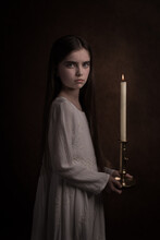 Classic Dark Studio Portrait Of A Woman With A Candle