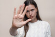 Woman's palm close up, gesture stop and don't move, stop domestic violence