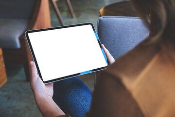 Mockup image of a woman holding digital tablet with blank white desktop screen