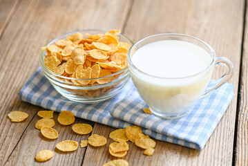 Wall Mural - cornflakes bowl breakfast food and snack for healthy food concept, morning breakfast fresh whole grain cereal, cornflakes with milk on table food wooden background