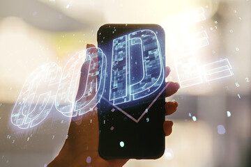 Wall Mural - creative code word hologram and hand with cell phone on background, artificial intelligence and neur