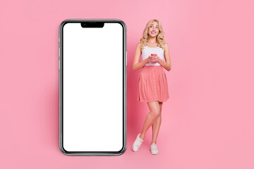 Canvas Print - Full length body size view of charming trendy minded girly girl using gadget copy space eshop isolated over pink pastel color background