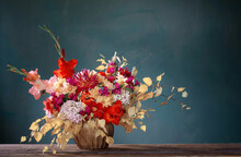 Autumn Bouquet With Red And Yellow Flowers In Ceramic Vase On Dark Background