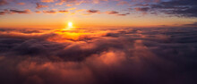 Majestic Photo Above The Clouds Of Setting Sun Under Horizon. Vibrant Colours Of Burning Clouds Lit By Last Sun Rays