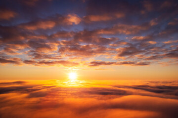 Canvas Print - Beautiful landscape above the clouds of setting sun. Aerial photo of sun going under horizon, dream like atmosphere