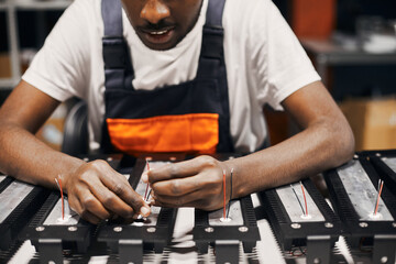 Wall Mural - factory worker connecting wires at circuit