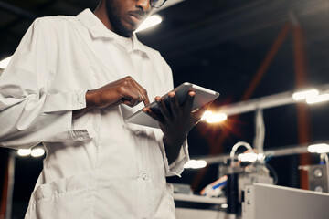 Wall Mural - african engineer working with tablet at factory