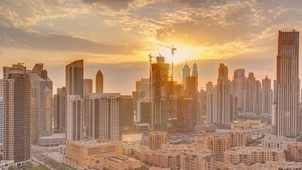 Dubai's business bay towers at sunset aerial timelapse. Rooftop view of some skyscrapers