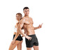 © Mike Orlov - Fit couple at the gym shows on copy space isolated on white background . Fitness concept. Healthy life style. Mr and Mrs Fitness.