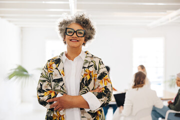 Wall Mural - Mature businesswoman standing in a meeting room