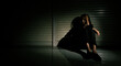 © Jade - Woman depressed from sad stress pain despair problem, person sit on closed shop on corridor alone with emotion lonely desperate upset head down. Head in hand no way out concept, copy space