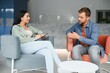 © Serhii - Psychologist talking with patient on therapy session. Depressed man speaking to a therapist while she is taking notes.