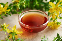 A Bowl Of Red Oil Made From St. John's Wort Flowers In Summer