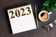 © missmimimina - New year resolutions 2023 on desk. 2023 resolutions list with notebook, coffee cup on table. Goals, resolutions, plan, action, checklist concept. New Year 2023 template, copy space