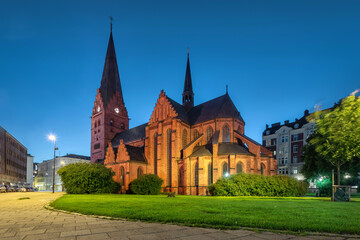 Sticker - Malmo, Sweden. View of St. Peters Church at dusk