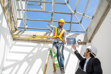 Wall Mural - Engineers with Businessmen discussing and checking solar cell for residential under construction.