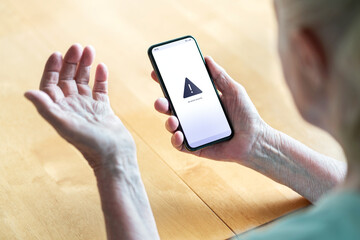 senior having problem with phone and technology. old woman with error message in smartphone screen. 