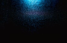 Black Abstract Background With Bursts Of Blue Fine Grain. Fine Turquoise Particles Falling
