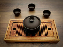Gong Fu Brewing Gaiwan  And Tea Cups On A Wooden Background.