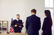 © Studio Romantic - American judge in robe uniform enforces punishment on young man. Lawyer and defendant listening to judge giving fair judgment, back rear view. Concept of law, justice, and courthouse trials in US