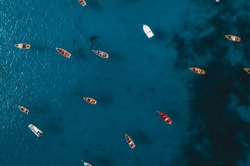 Colorful boats in the ocean, drone view, top view