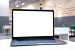 © velishchuk - Laptop with white screen in business office or shopping mall. Empty copy space, blank screen mockup. Soft focus laptop with interor background. Travel, study and office work concept