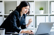 © sirichai - Asian businesswoman looking at laptop computer with excited and raised hands up celebrate winner success victory business , receiving reward career and good news