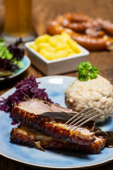 Wall Mural - portion of fresh roasted pork on a blue plate