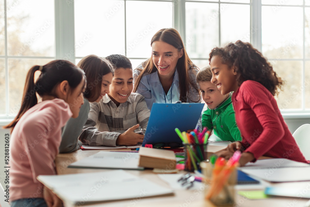 Diverse School Children And Teacher Woman Having Class In Classroom ...
