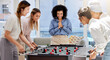 © Malik E/peopleimages.com - Team building, break and business women playing game in office lounge room having fun and bonding together. Trendy, cool and diversity of creative staff with fun mini table football match activity
