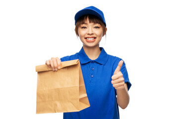 Sticker - service and job concept - happy smiling delivery woman in blue uniform with takeaway food in paper bag showing thumbs up gesture over white background