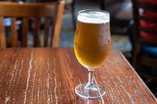Pint Glass Of British Light Pilsner Ot Lager Beer Served In Old Vintage English Pub
