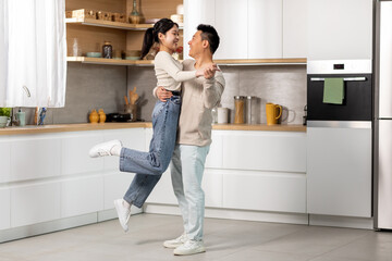 Wall Mural - Romantic chinese lovers dancing waltz at kitchen