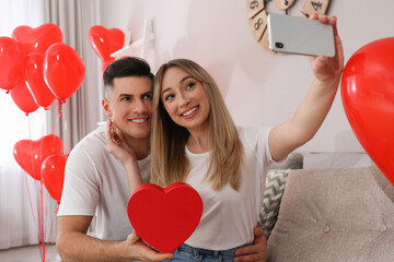 Canvas Print - Lovely couple taking selfie at home. Valentine's day celebration