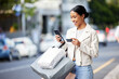 © M Einero/peopleimages.com - Happy woman with her phone, credit card and bag after shopping in the city. Young latin female carrying bags, spending money, looking for sales and enjoying online eCommerce store sale with a smile