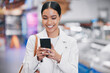 © M Einero/peopleimages.com - Happy woman with phone reading funny social media meme on the internet while in a mall. Female with a smile while for discount coupon or texting a contact on a mobile smartphone after retail shopping